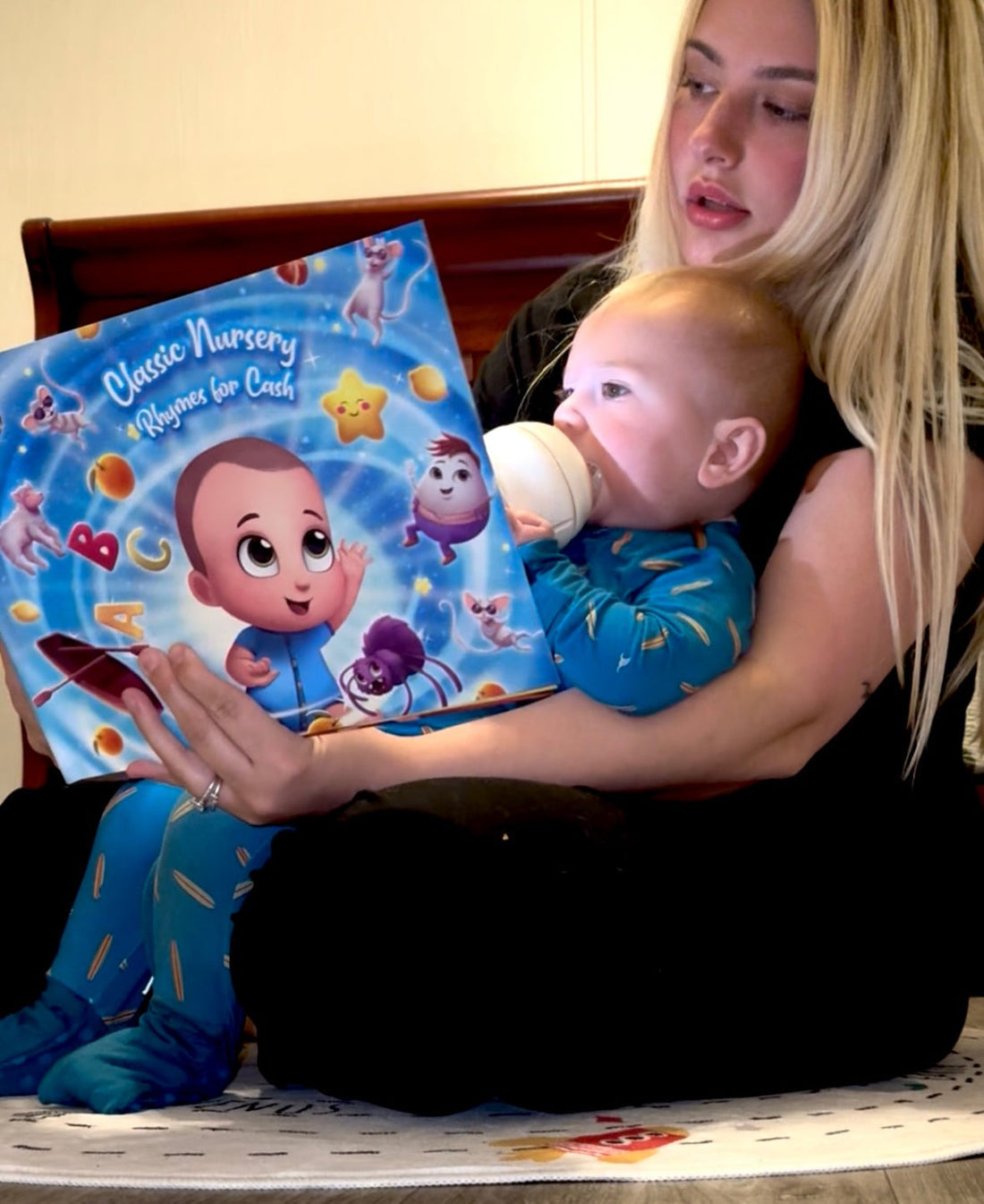 Mother reading a book to baby.