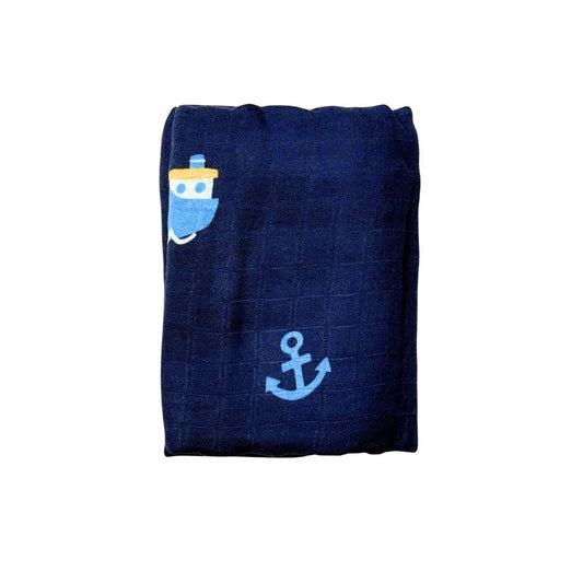 Swaddle blanket with tugboat and anchors pattern on blue background